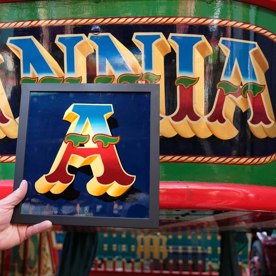 Example of handpainted lettering next to the original at Carters Steam Fair