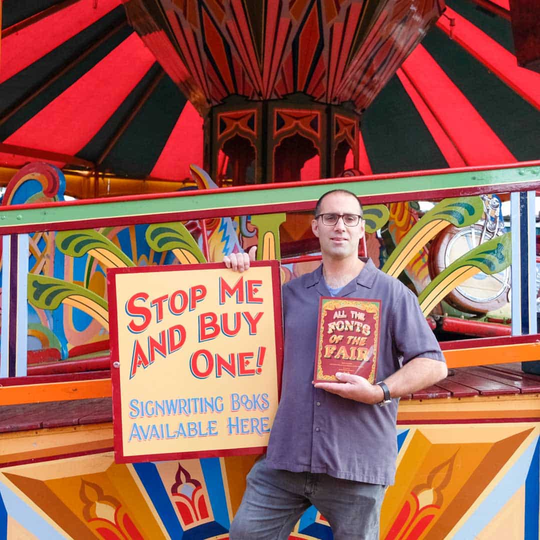 Joby Carter with all the fonts of the fair book at Carters Steam Fair