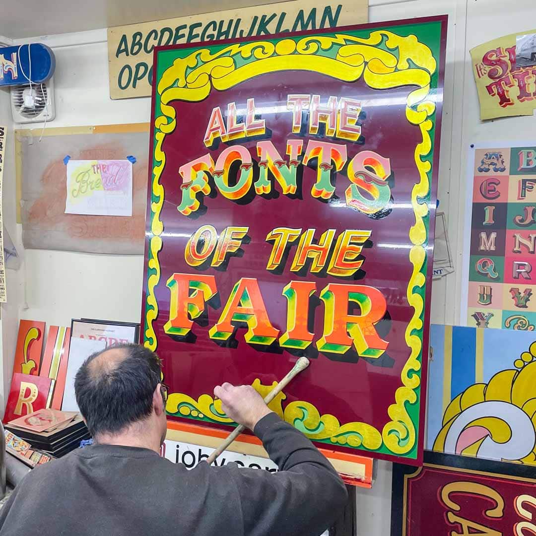 Joby Carter painting the front cover of the book