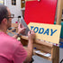 Joby Carter using a set square to draw letters accurately