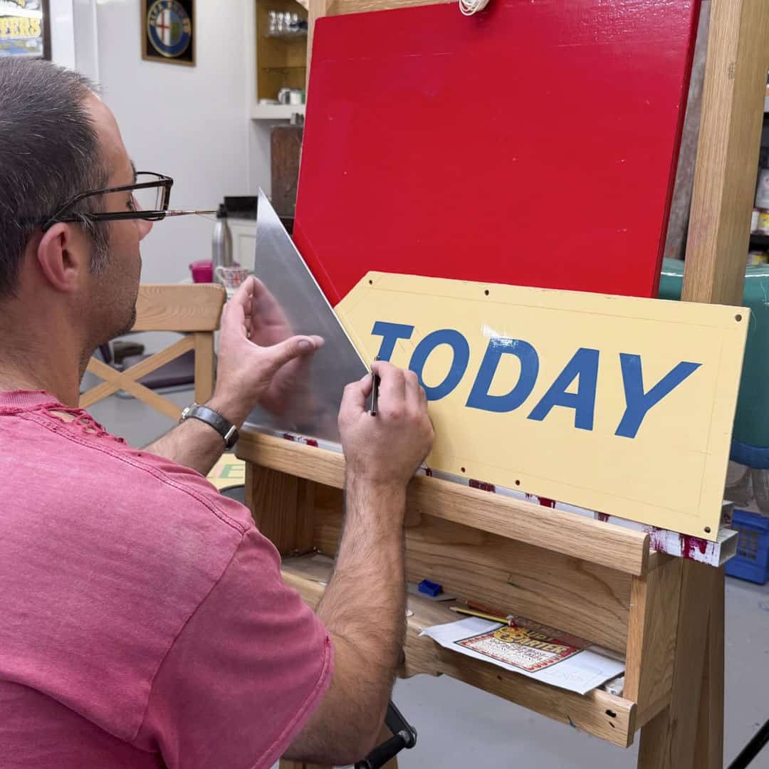 Joby Carter using a set square to draw letters accurately