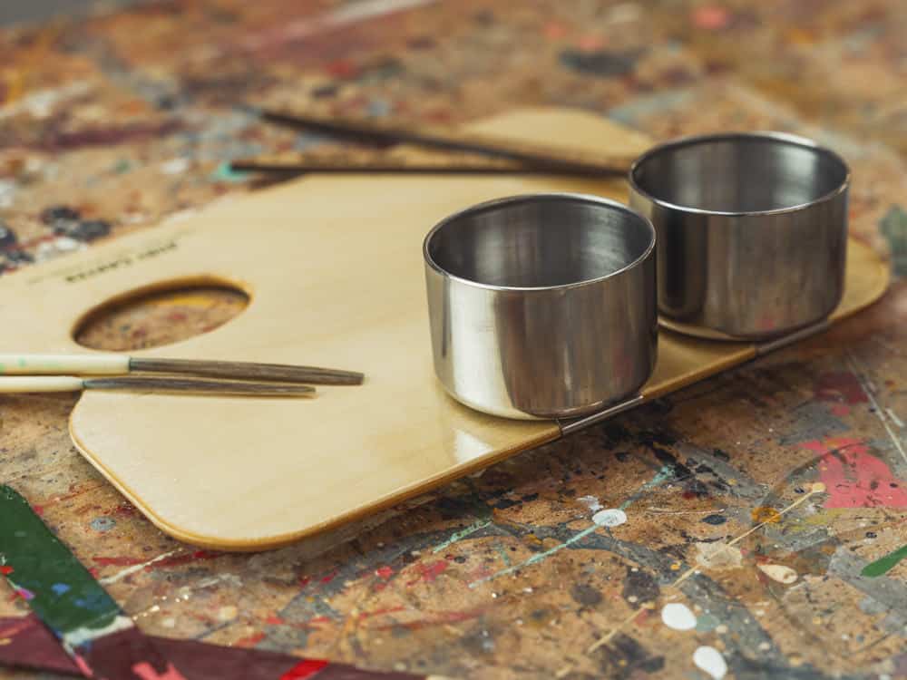 Traditional signwriting tools: palette, dippers and lining brush