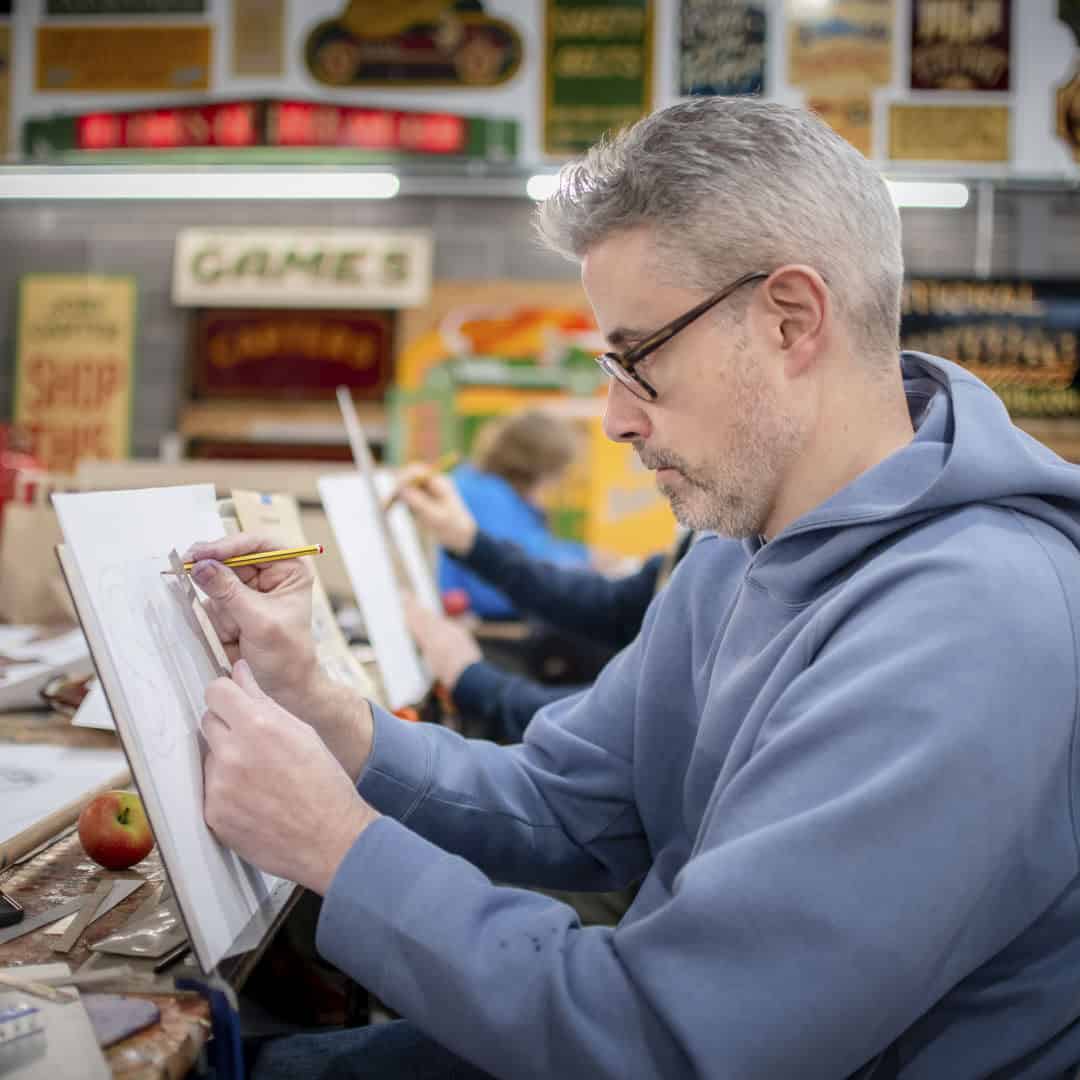 A student on Joby Carter's signwriting course