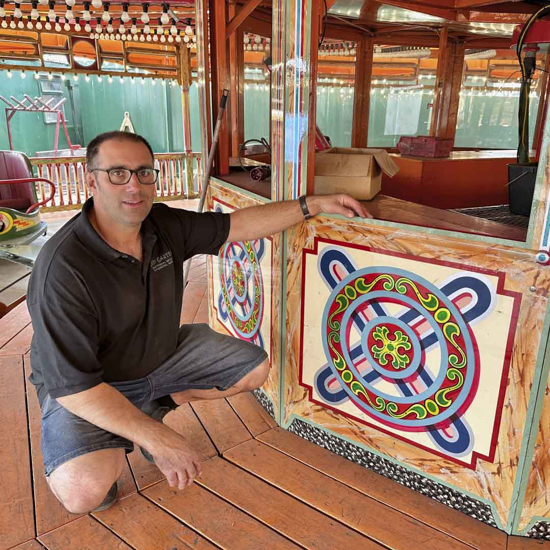 Joby Carter next to artwork on the lightning skid ride
