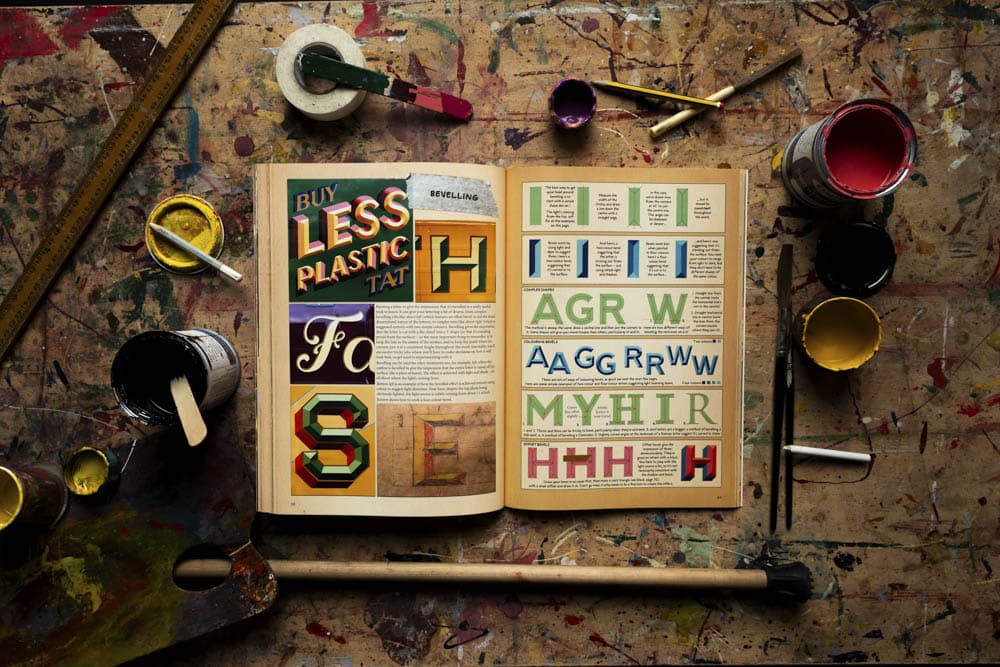 Joby Carters book signwriting tips tricks and inspiration on a table showing the page about bevelling with step by step instructions
