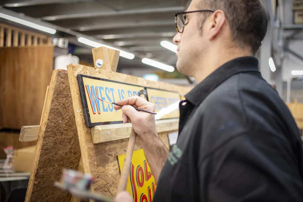 Joby Carter painting letters by hand