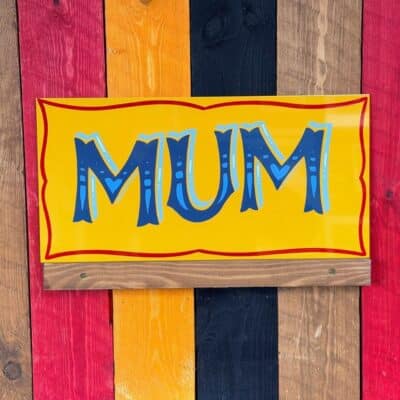 Yellow and blue hand painted sign by Joby Carter